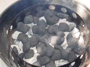 Half chimney of unlit charcoal added to hot coals