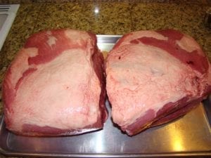 Two untrimmed pork butts removed from packaging