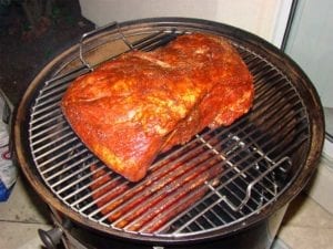 Pork butts go into the Weber Smokey Mountain Cooker