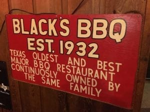 Sign touting Black's as one of the oldest joints in Texas