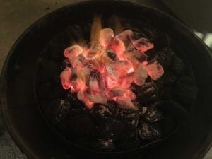 Hot coals dumped on top of unlit charcoal