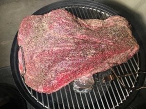 Brisket goes fat side down onto the top cooking grate