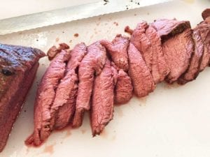 Thin slices of tri-tip carved by hand