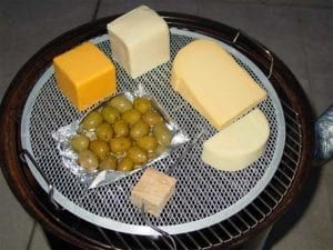 A variety of cheeses and olives for cold smoking