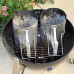 Two Weber chimney starters on charcoal grate