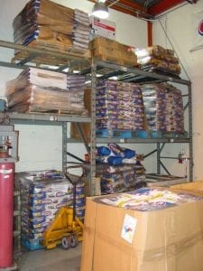 Pallets of old and new Kingsford are stored in the warehouse adjacent to the testing lab. Notice the Weber kettle box on the top shelf.