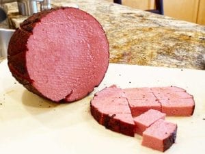 Cutting smoked bologna into cubes