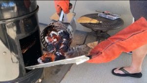 Adding hot charcoal using cardboard chute